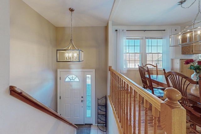 entrance foyer with stairway and a chandelier