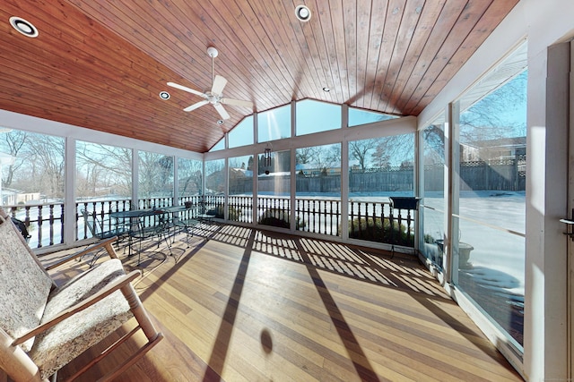 sunroom with lofted ceiling, wood ceiling, and ceiling fan