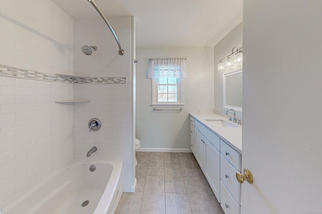 bathroom with bathing tub / shower combination, toilet, vanity, tile patterned flooring, and baseboards