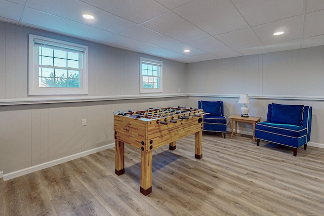 game room with light wood-style flooring, baseboards, a drop ceiling, and recessed lighting