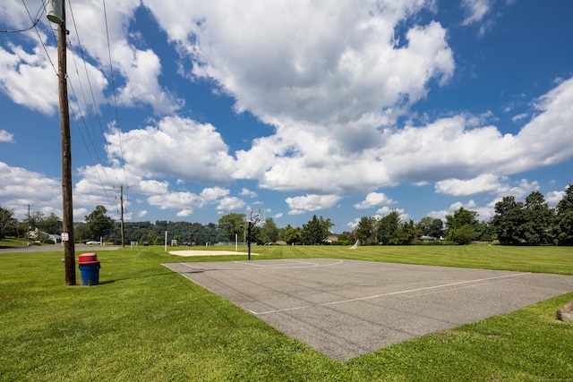 surrounding community with community basketball court and a lawn