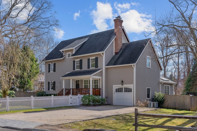 view of front of property with a gate, driveway, a chimney, a garage, and a fenced front yard