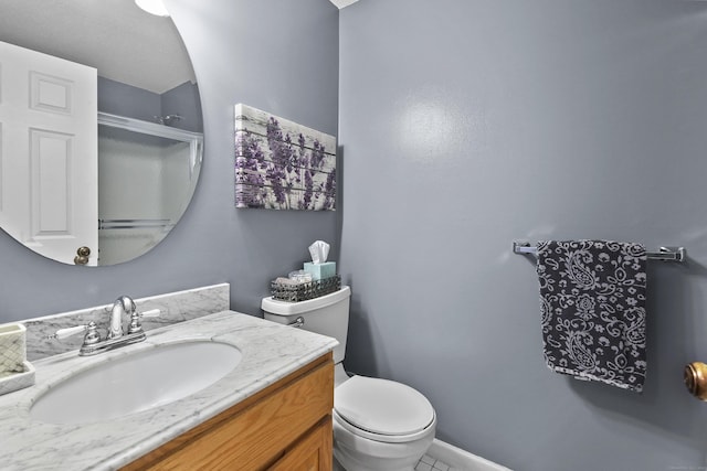 bathroom with toilet, baseboards, and vanity