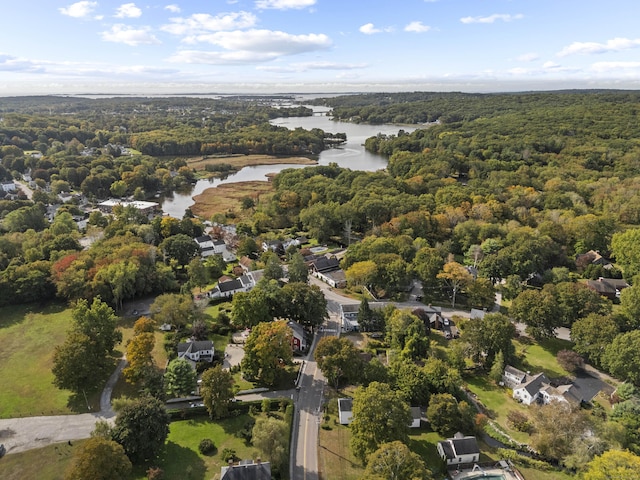 birds eye view of property featuring a water view and a wooded view