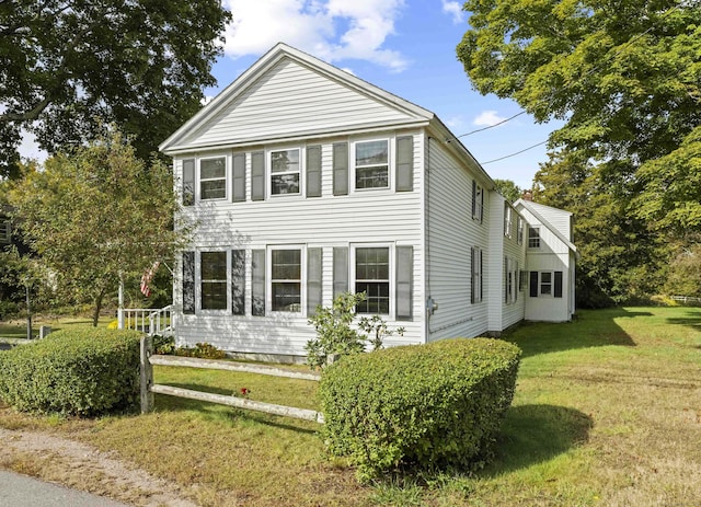 view of side of home with a lawn