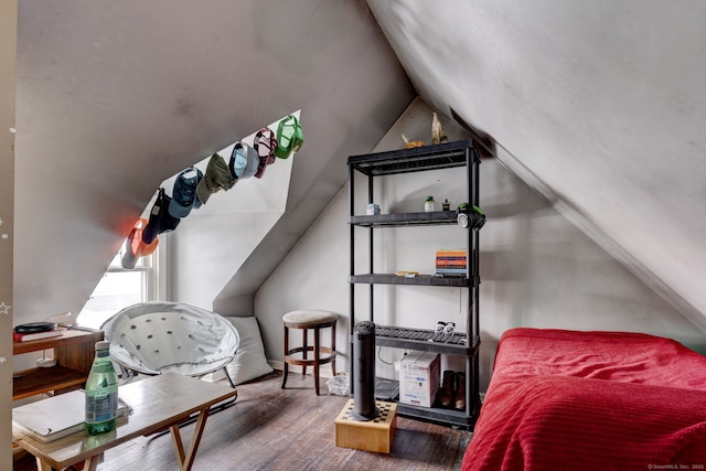 bedroom with vaulted ceiling and wood finished floors