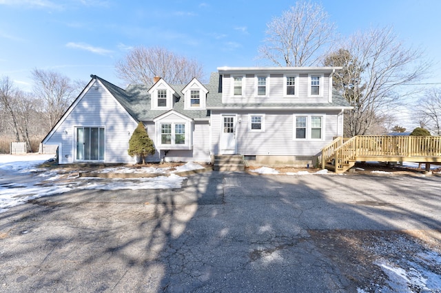 view of front of property with a shingled roof and a deck