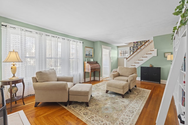 living room featuring stairway, wood finished floors, and baseboards