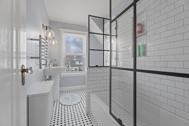 bathroom featuring a bathtub, baseboards, a tile shower, and tile patterned floors