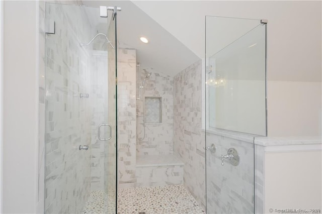 bathroom featuring recessed lighting, a shower stall, and vaulted ceiling