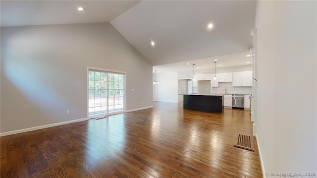 unfurnished living room with baseboards, visible vents, high vaulted ceiling, recessed lighting, and dark wood-type flooring