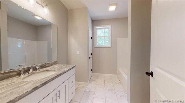 full bathroom with marble finish floor, a bathing tub, baseboards, walk in shower, and vanity