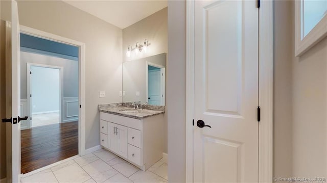 bathroom featuring marble finish floor and vanity