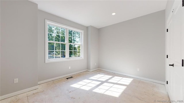 unfurnished room featuring visible vents and baseboards