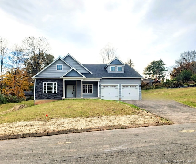 view of front facade featuring aphalt driveway, a front yard, a porch, and a garage