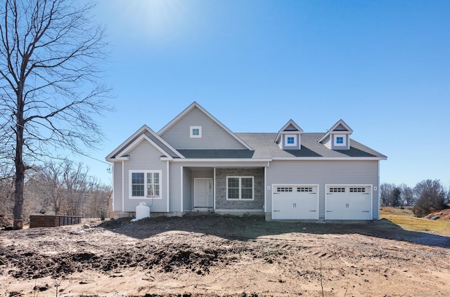 view of front of home featuring an attached garage and roof with shingles