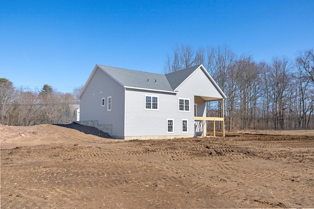 view of home's exterior with a shingled roof