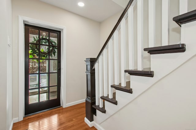 foyer with stairway, wood-type flooring, baseboards, and recessed lighting