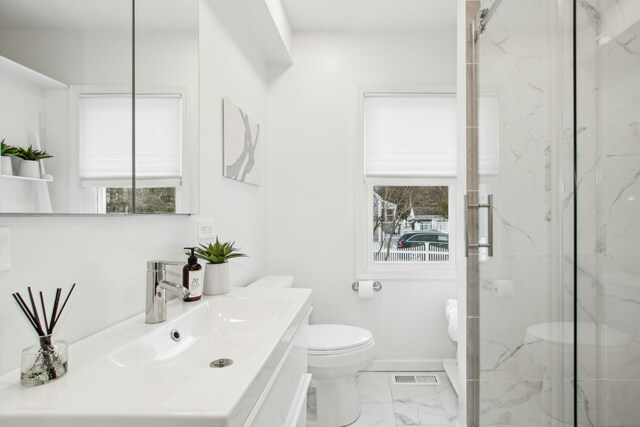 bathroom with marble finish floor, a marble finish shower, visible vents, toilet, and baseboards