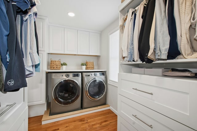 clothes washing area featuring light wood-type flooring, plenty of natural light, recessed lighting, and washing machine and clothes dryer