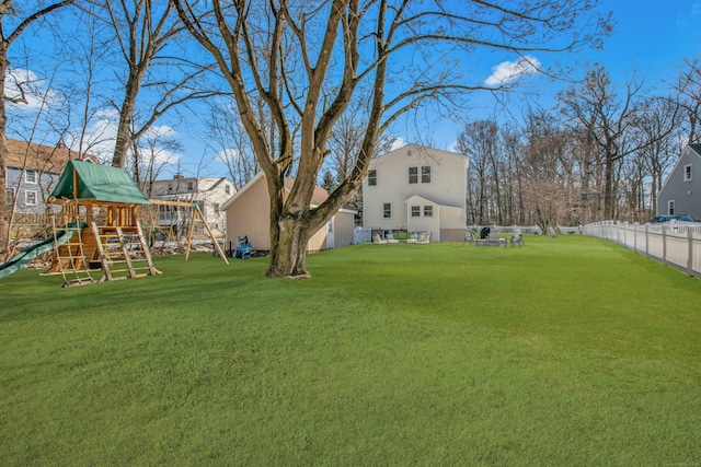 view of yard with a playground and fence