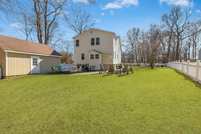 rear view of house featuring a patio area, a fenced backyard, and a yard