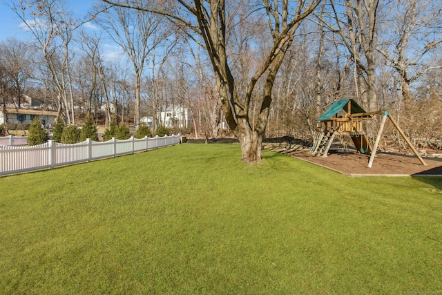 view of yard featuring fence and a playground