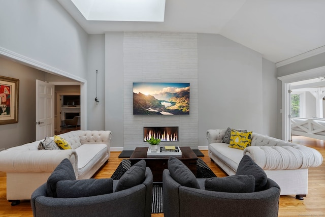 16 Whitehall Pl, Farmington, CT 06032 - living area featuring light wood-style floors, a skylight, a fireplace, and vaulted ceiling