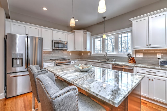40 Newbury Ct Unit 40, North Haven, CT 06473 - kitchen with appliances with stainless steel finishes, a kitchen breakfast bar, white cabinets, light wood-type flooring, and recessed lighting