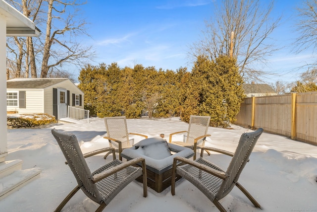 view of patio / terrace with fence and an outdoor structure