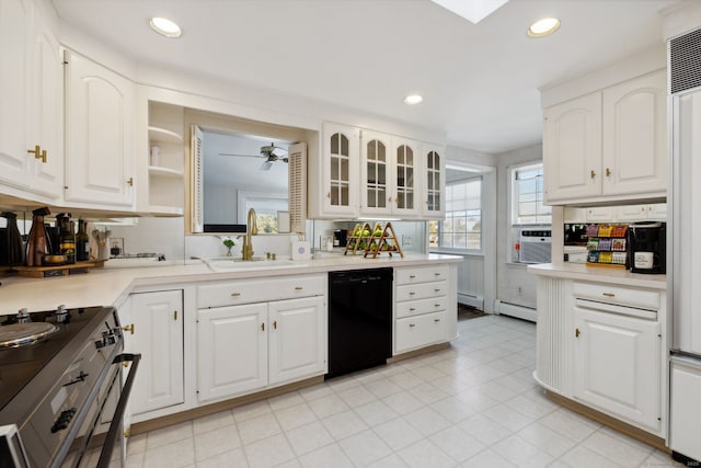 kitchen with black dishwasher, light countertops, and white cabinets