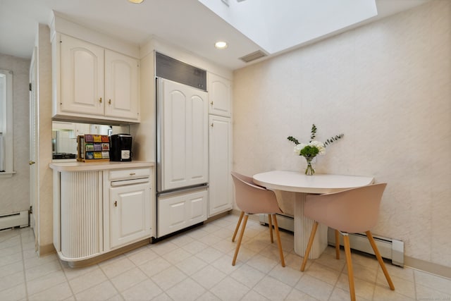 kitchen featuring a skylight, recessed lighting, light countertops, visible vents, and white cabinets