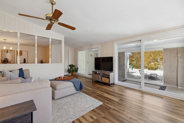 living room featuring lofted ceiling, a chandelier, and wood finished floors