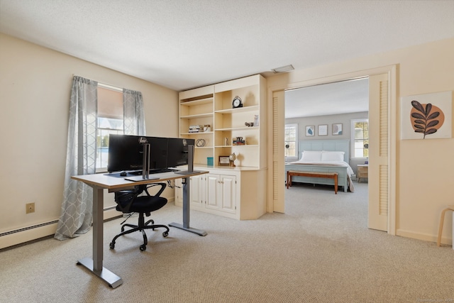 office with light carpet, visible vents, a baseboard heating unit, and a textured ceiling