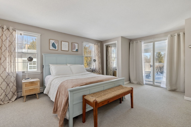 bedroom featuring baseboards, light colored carpet, and access to exterior