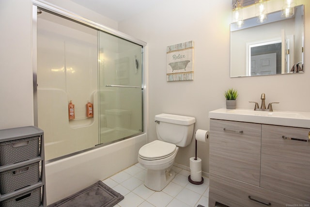 full bathroom with vanity, bath / shower combo with glass door, tile patterned flooring, and toilet