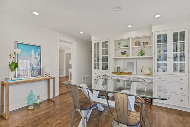 dining space featuring baseboards, wood finished floors, and recessed lighting