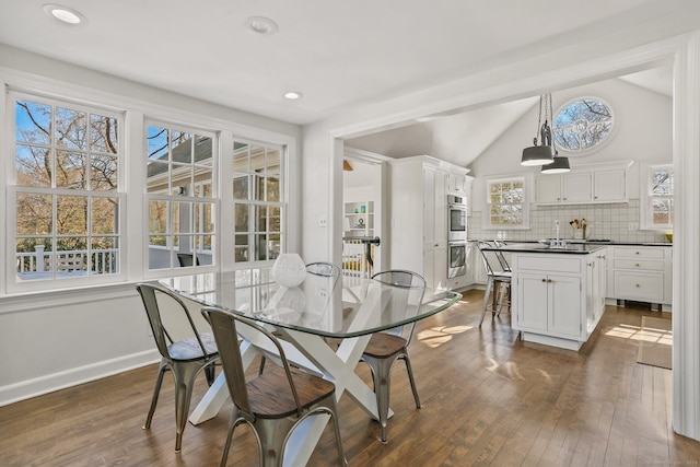 dining area with lofted ceiling, dark wood-type flooring, recessed lighting, and baseboards