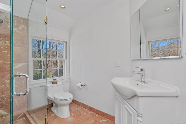 bathroom with lofted ceiling, toilet, vanity, baseboards, and a shower stall