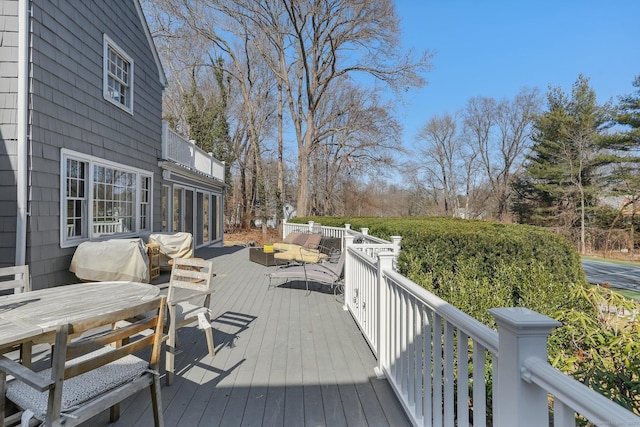 wooden deck with a grill