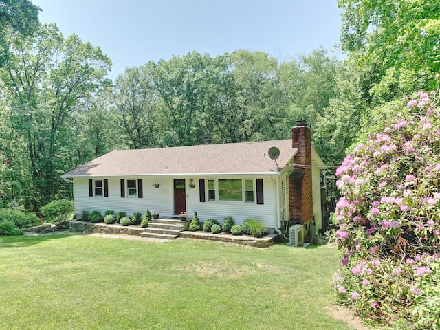 single story home featuring a chimney and a front lawn