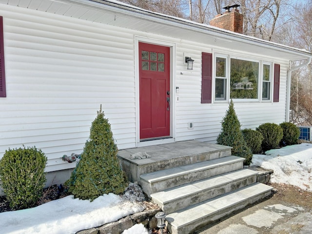 entrance to property with a chimney