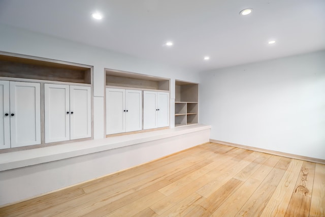 spare room with light wood-style floors, baseboards, and recessed lighting