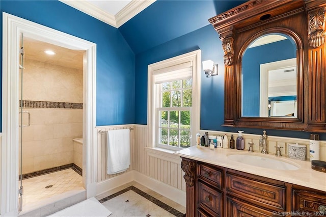 bathroom featuring ornamental molding, vanity, and an enclosed shower