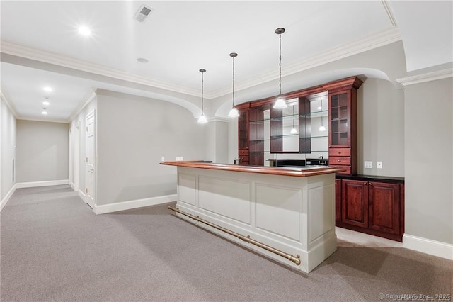 bar with light carpet, ornamental molding, and decorative light fixtures