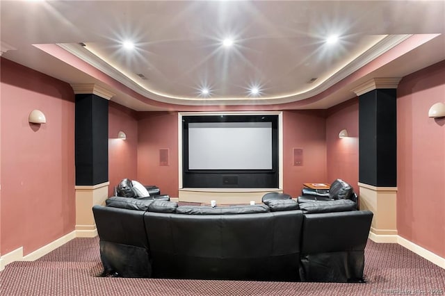 home theater with a tray ceiling and carpet