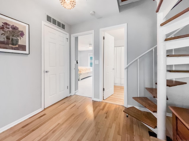 interior space with wood finished floors, baseboards, and visible vents