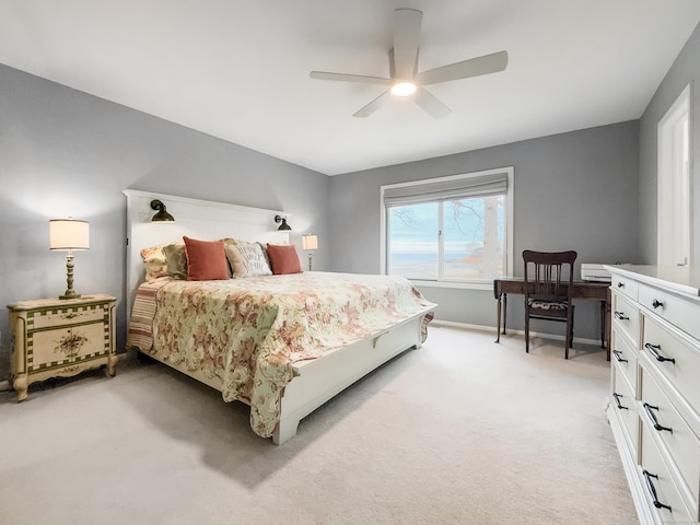 bedroom featuring light carpet and ceiling fan