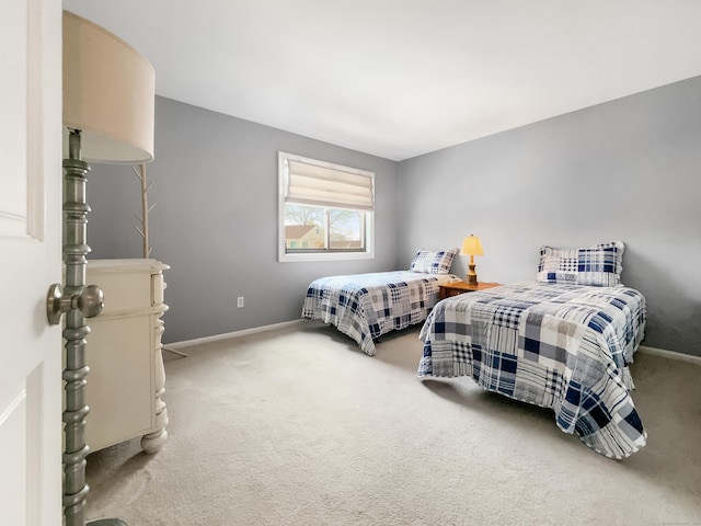 bedroom with baseboards and carpet flooring