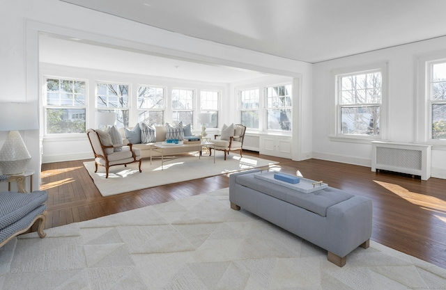 sunroom / solarium featuring radiator heating unit